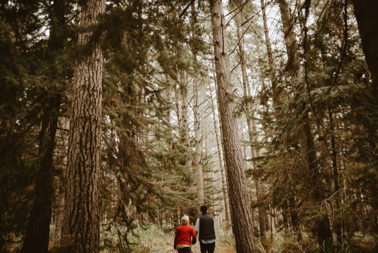 Couple walking in wood hill forest Auckland on photo shoot