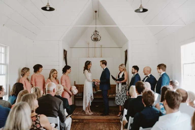 coulpe getting married in a old vintage white chapel or church